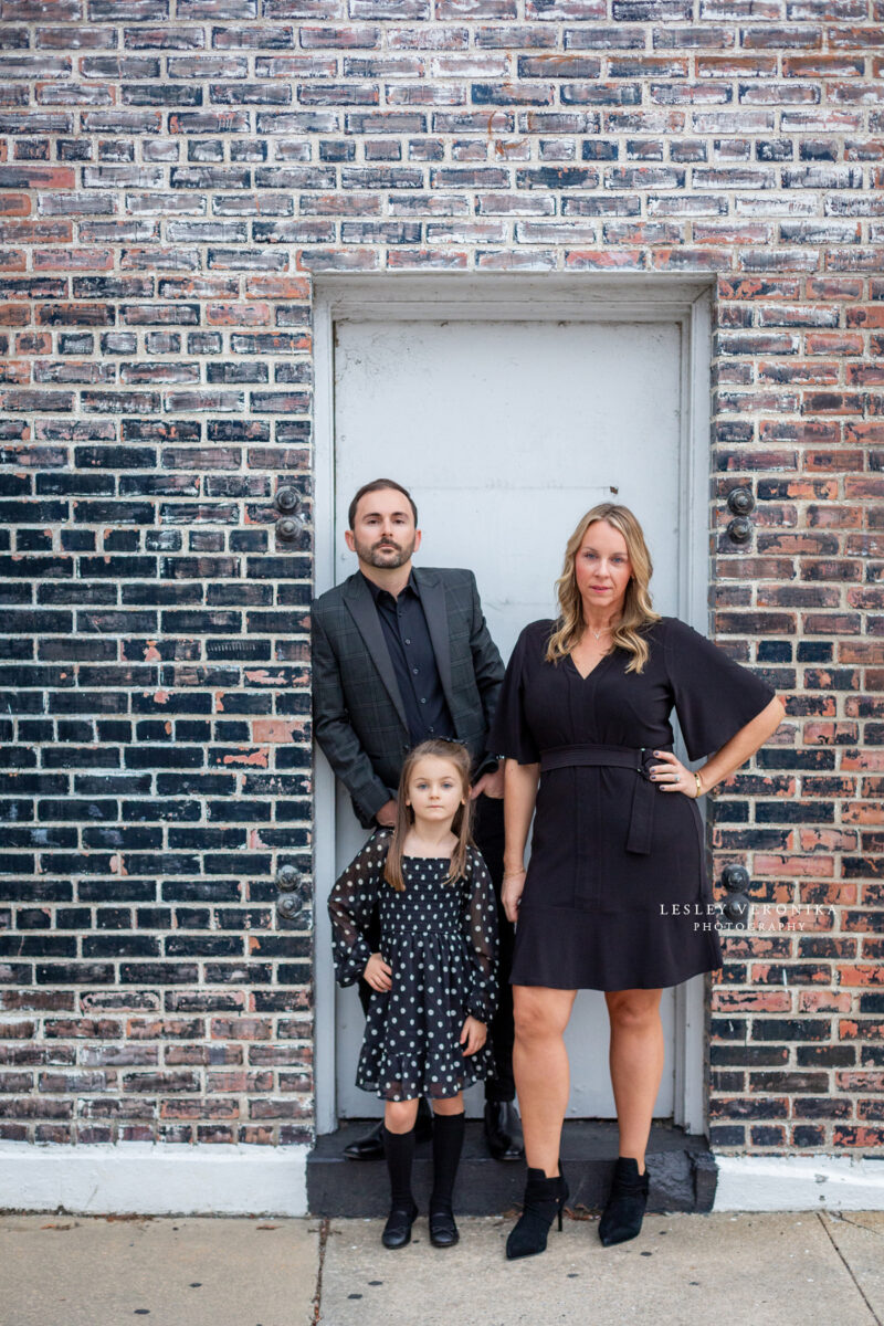 family portraits, wilmington nc family photographer, family of three, downtown wilmington, urban family portraits, children portraits, child, what to wear family session, what to wear black clothes, parents, loving family, sweet girl, family photography